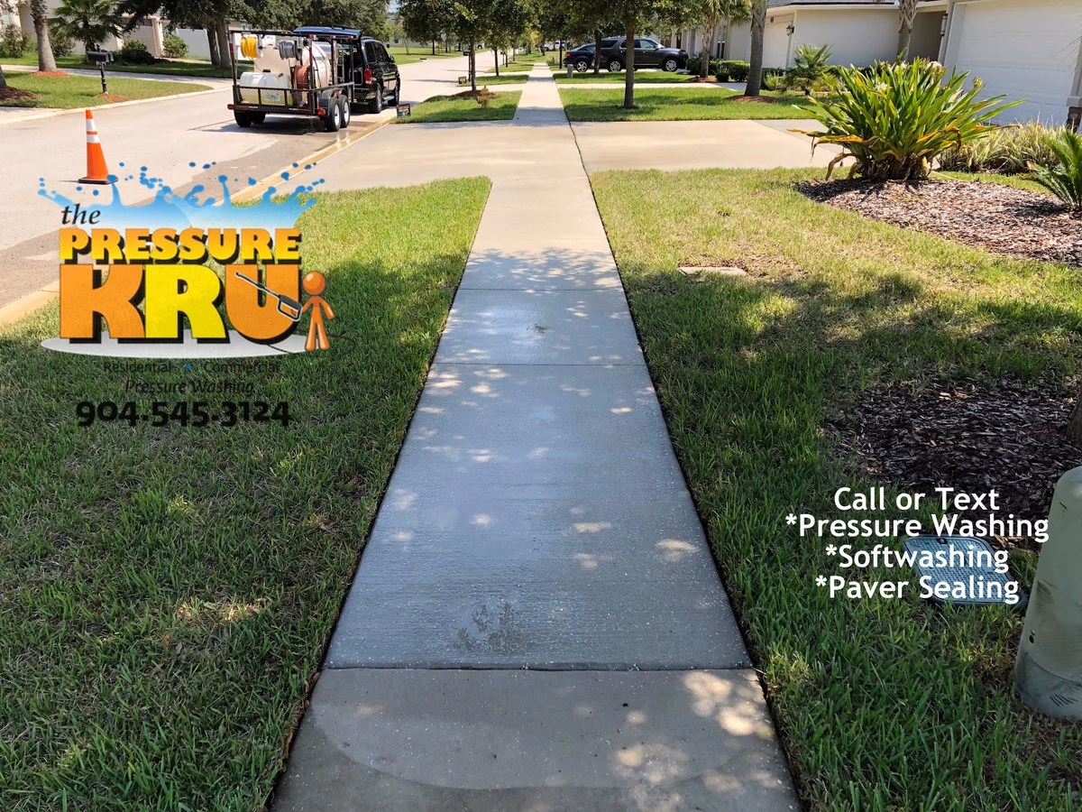 Pressure washing concrete driveway after removing deep set mold and algae in Ponte Vedra, FL