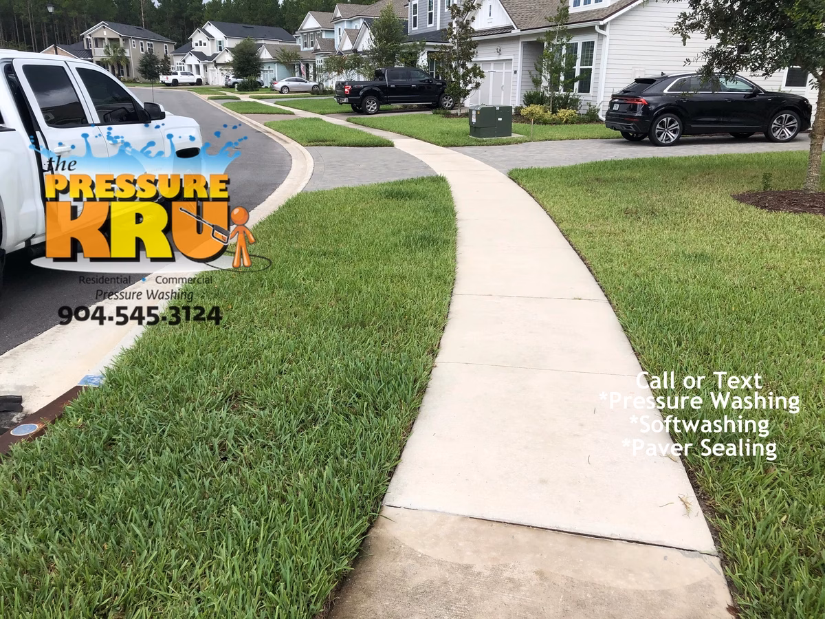 Top-Rated driveway cleaning service transforming dirty driveway in St. Augustine, FL. After cleaning the sidewalk and the curbs.
