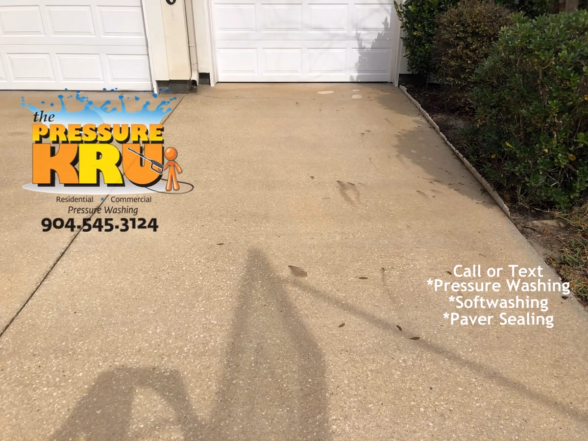 Clean white concrete driveway after professional pressure washing service in Jacksonville, FL.