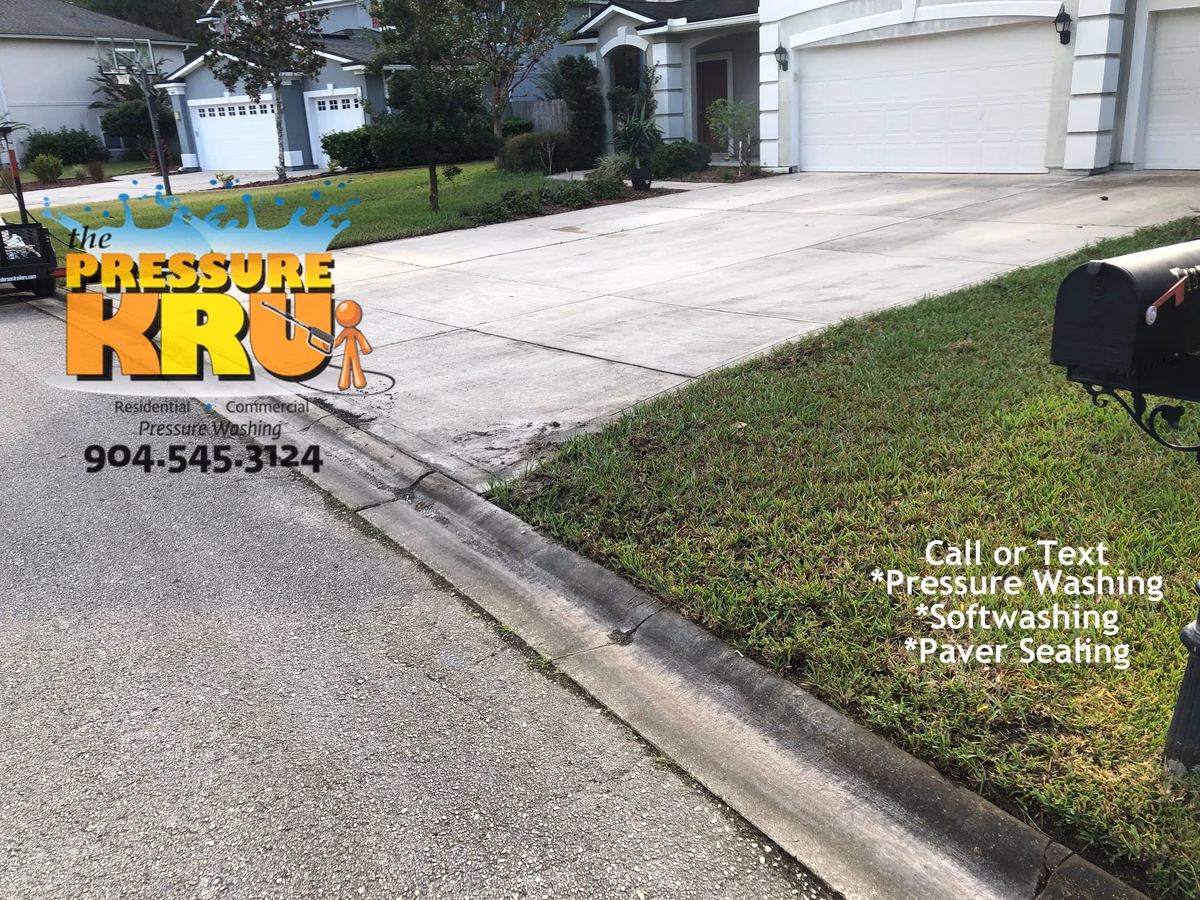 Power washing black mold driveway to remove dirt and grime in St. Augustine, FL 32092 before treatment.