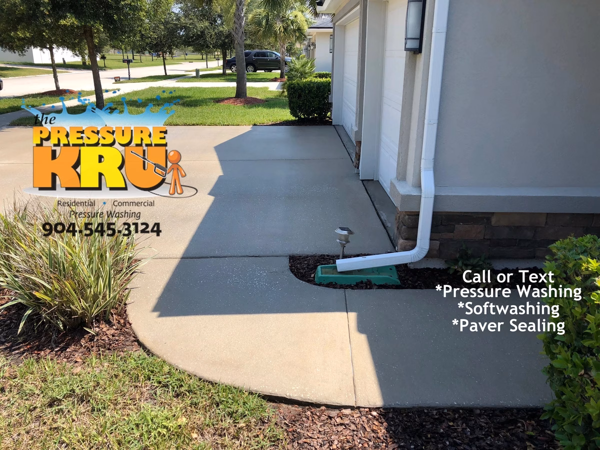 Spotless concrete driveway after power washing by local Ponte Vedra cleaning pros.