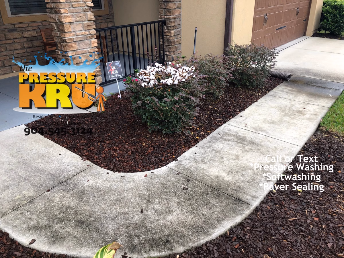 Professional concrete driveway before restoration and cleaning near St. Johns, FL.