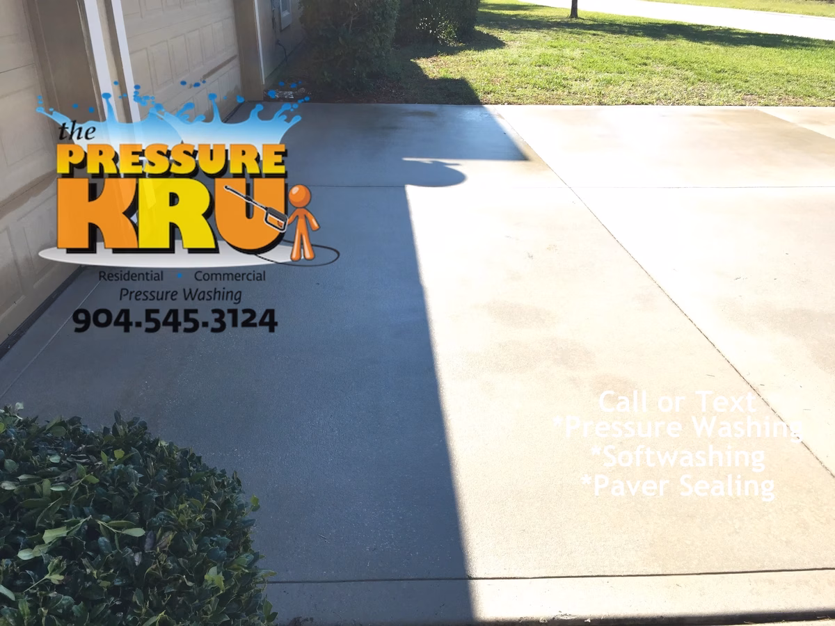 Clean white concrete driveway after professional pressure washing service in St. Augustine, FL
