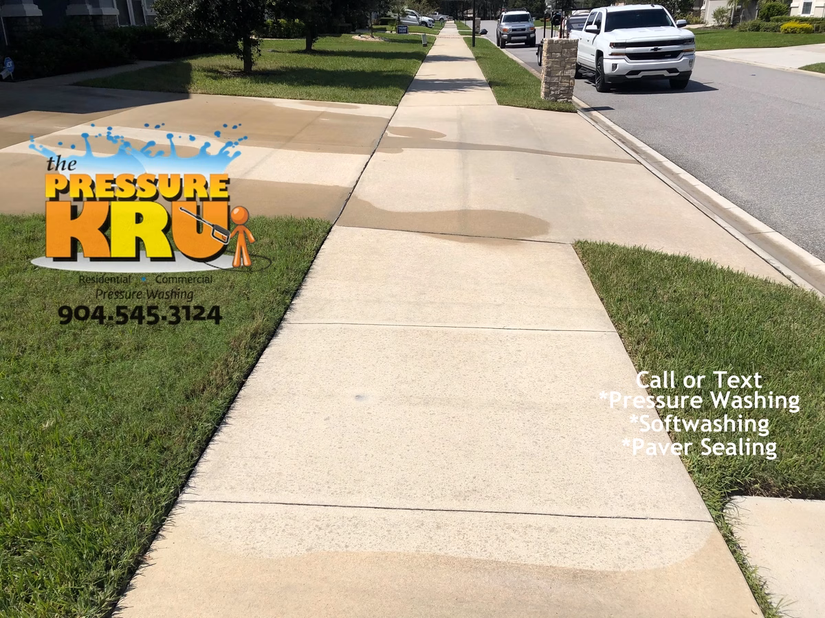 Annual pressure washing for concrete driveway customer after cleaning in St Augustine, FL.