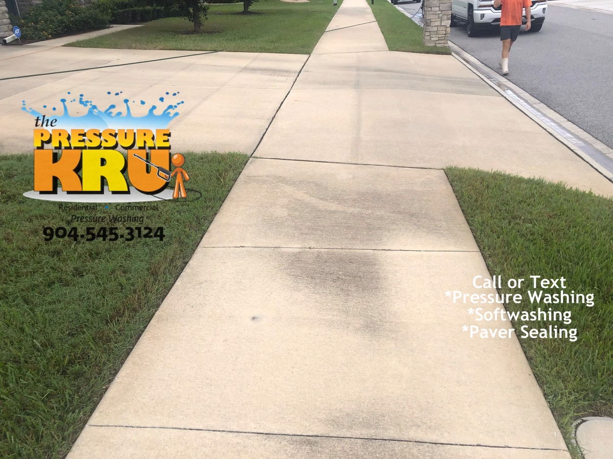 Annual pressure washing for concrete driveway customer before cleaning in St Augustine, FL.