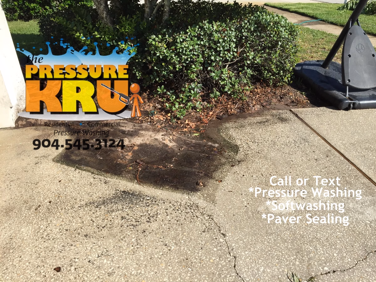 High pressure washing before removing moss and algae from driveway in St Augustine, FL.