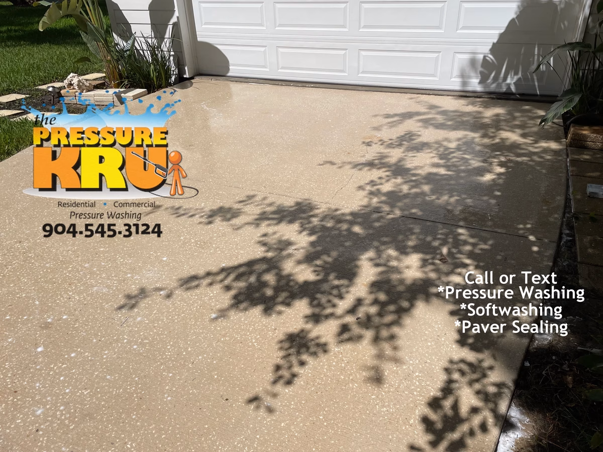 Clean white concrete driveway after professional power washing service in St. Johns, FL