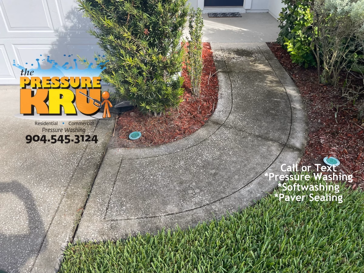 Heavy duty pressure cleaning of stained concrete driveway before service in Jacksonville, FL.