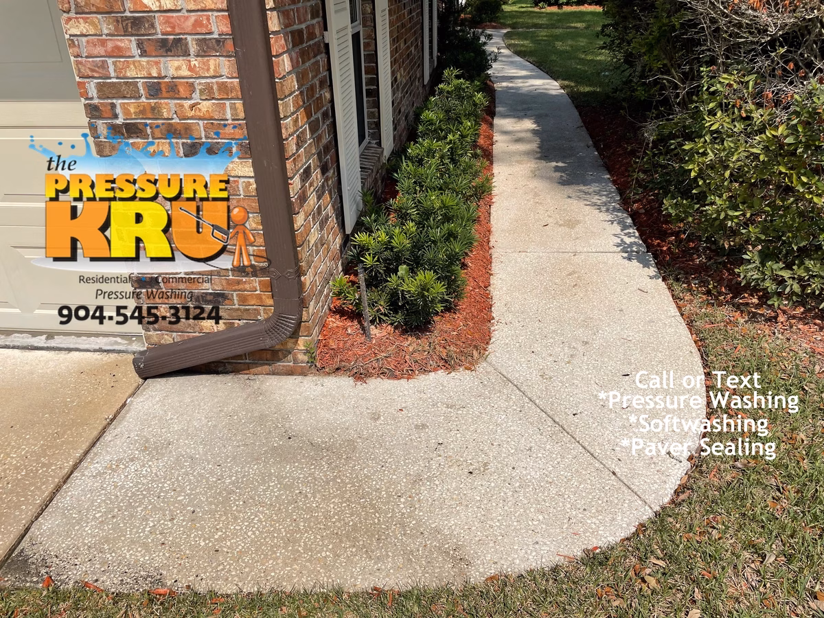 Spotless concrete driveway and walkway after pressure washing by The Pressure Kru in Saint Johns, FL.