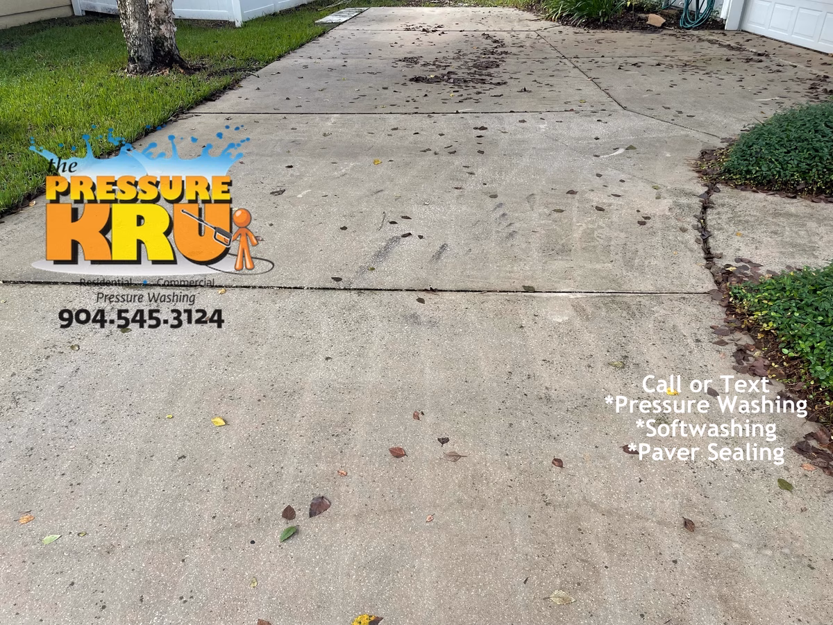 Professional pressure washing driveway before cleaning services in St Augustine, FL.