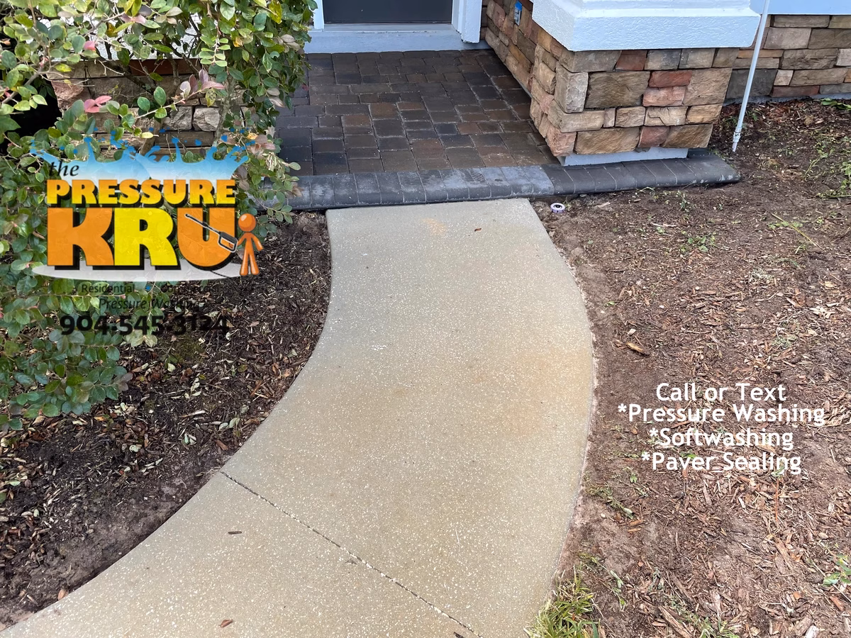 Power Washing Service cleaning large residential driveway in St Johns, FL. Home owner machine after calling.