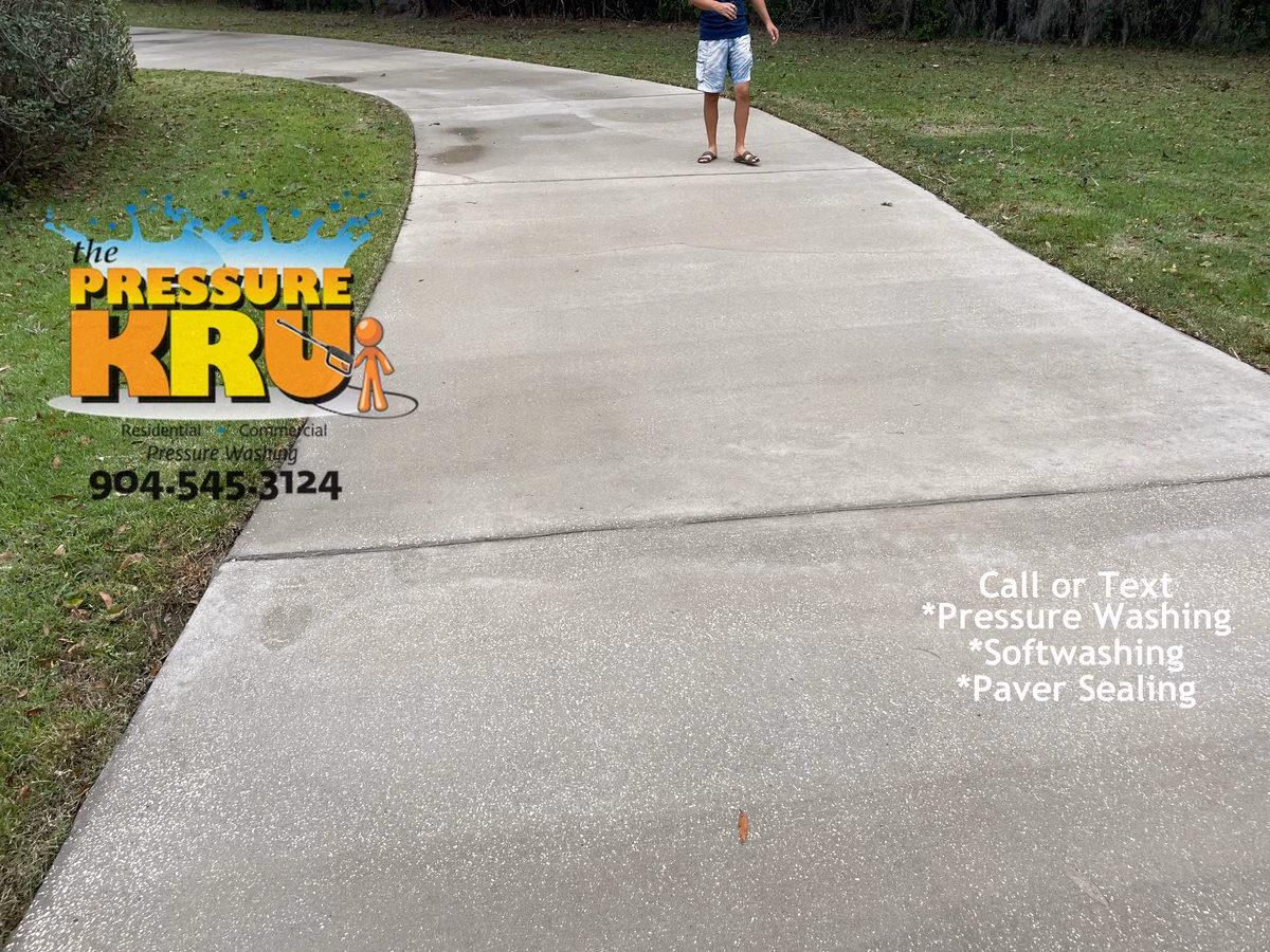 High Pressure Washing after low-pressure soft washing a concrete driveway in St. Augustine, FL