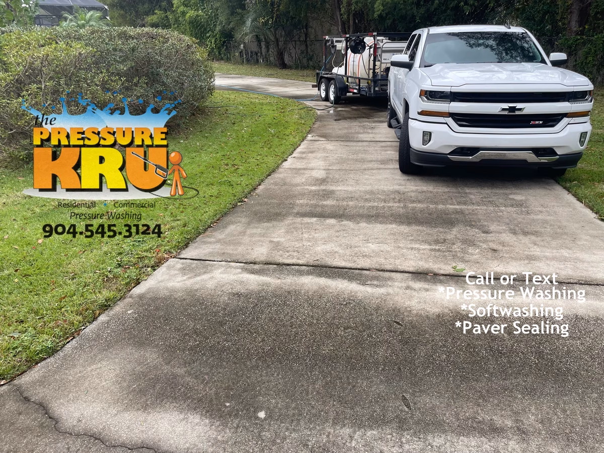 High Pressure Washing before low-pressure soft washing a concrete driveway in St. Augustine, FL