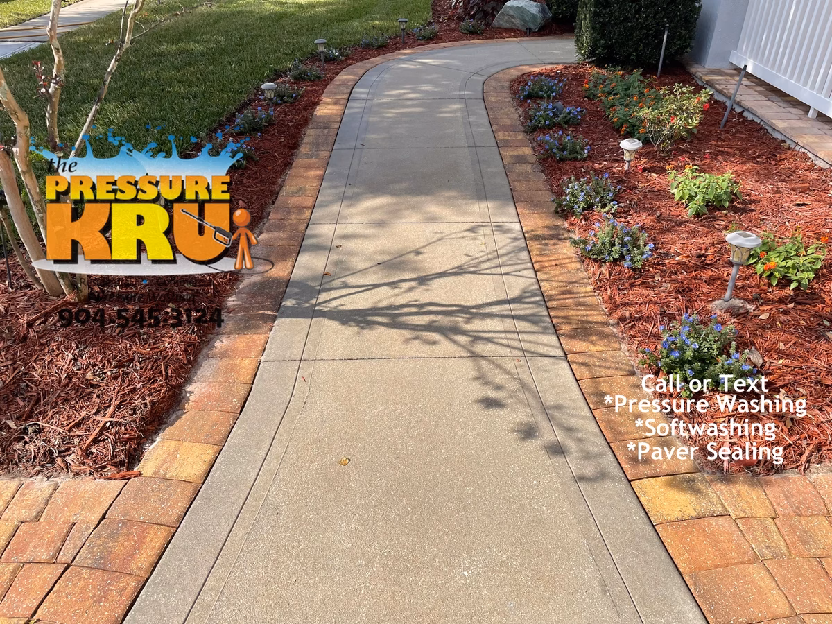 Heavy duty pressure cleaning of stained concrete driveway and sidewalk in St Johns, FL. After service.