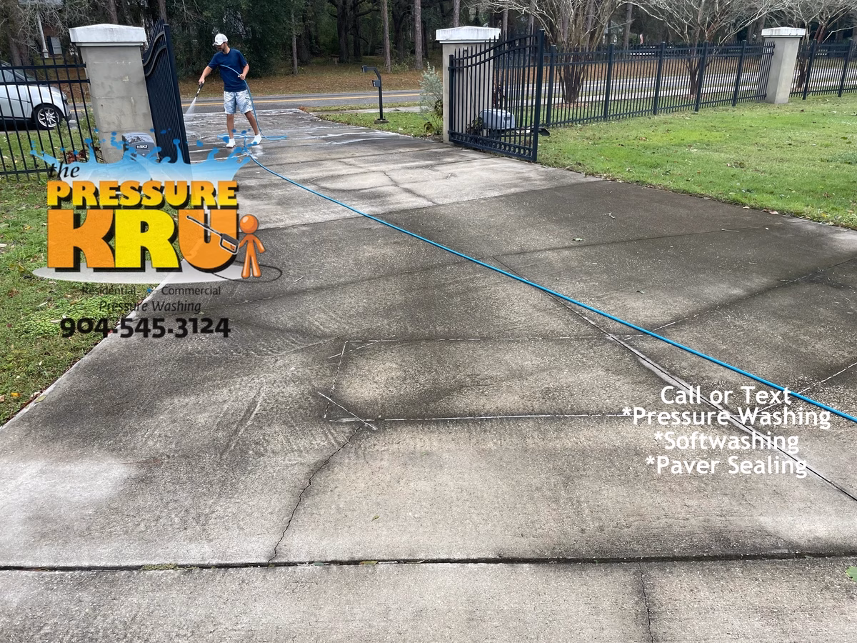 Power Washing Black concrete driveway to remove dirt and grime in St. Augustine, FL 32092. Soft Wash Pre-treatment before starting