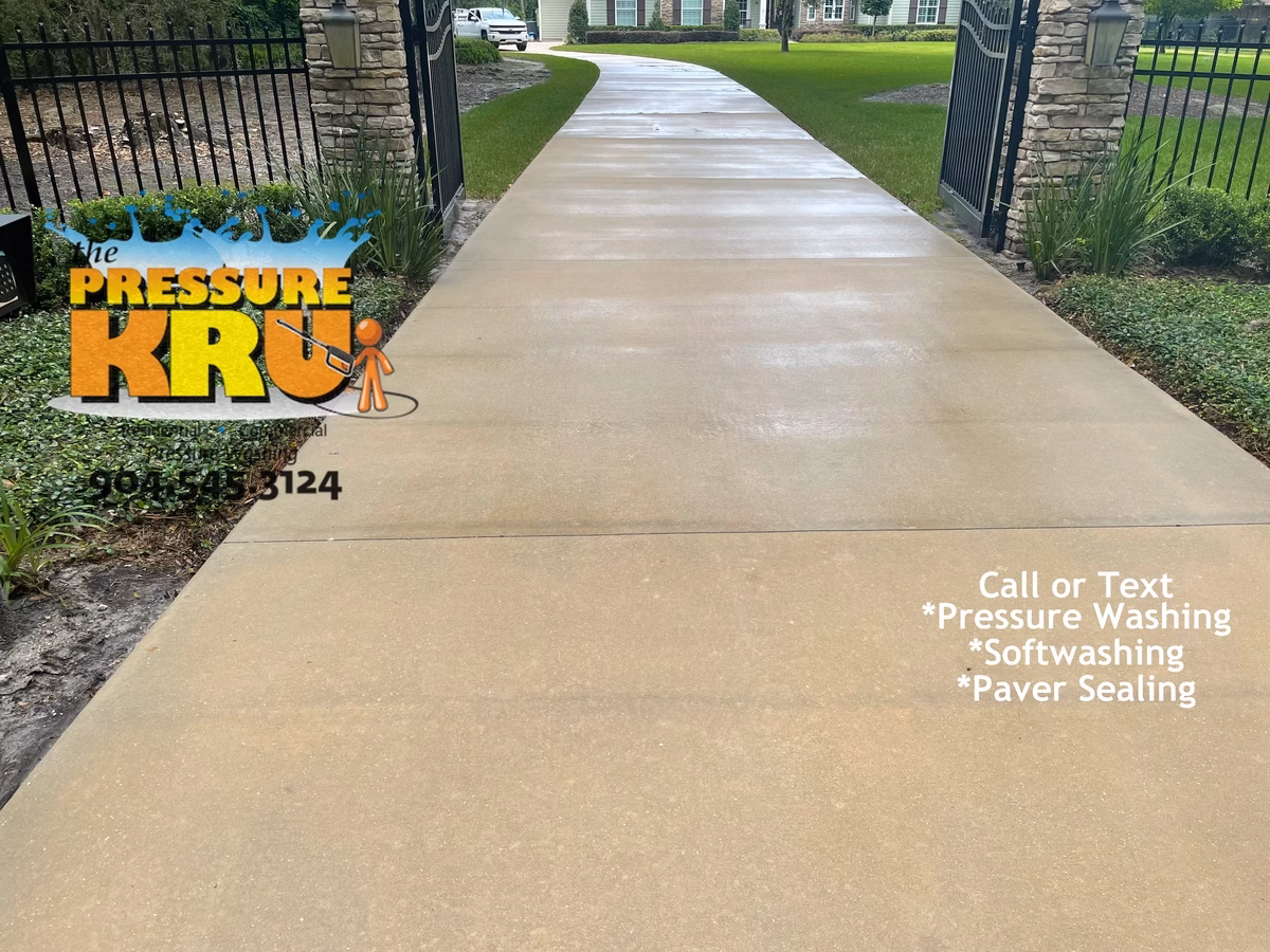 Bright concrete driveway under years of mold growth in Saint Johns, FL. After cleaning.
