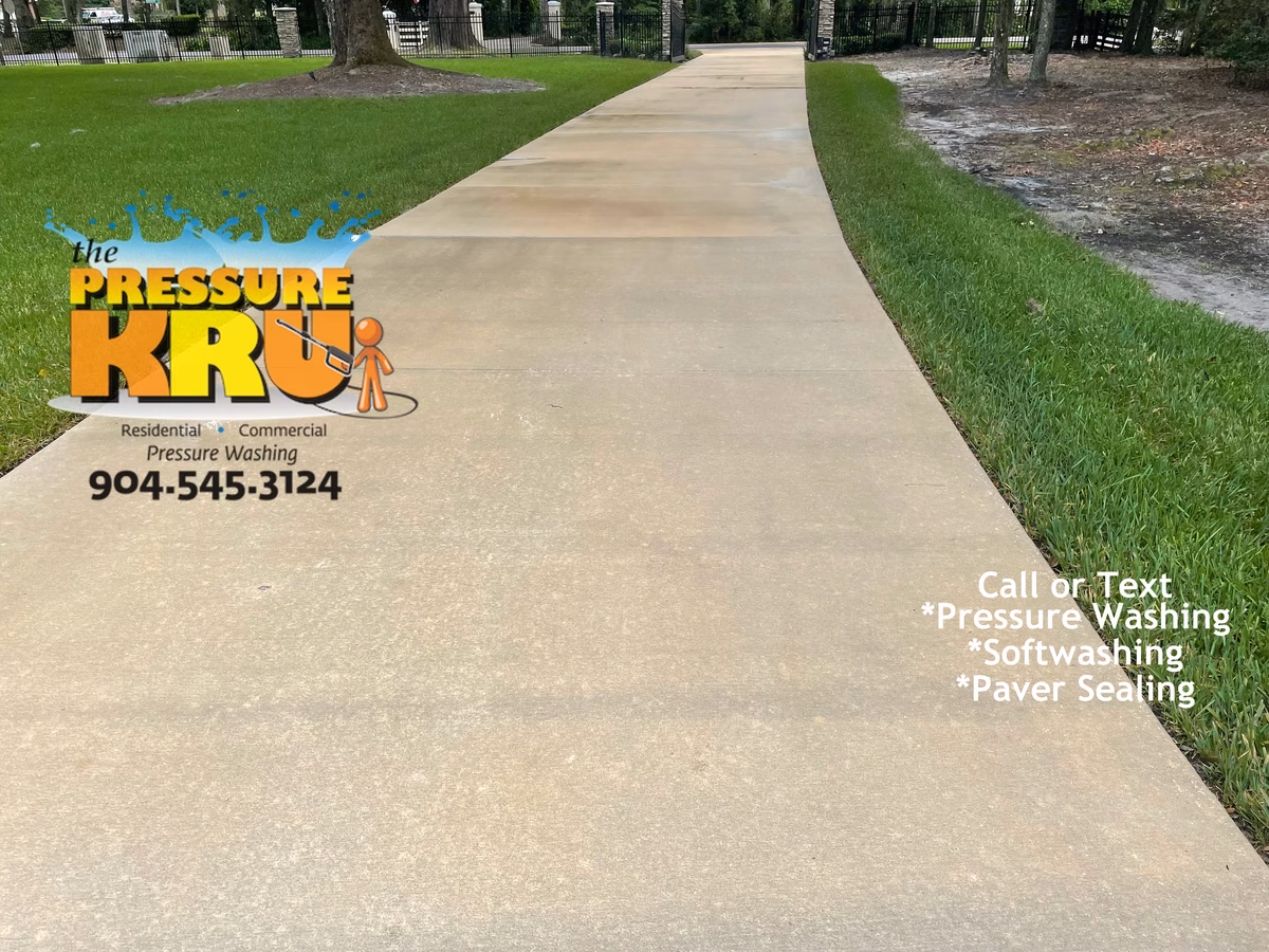 Pressure washing driveway in Saint Johns, FL. after soft wash treatment.