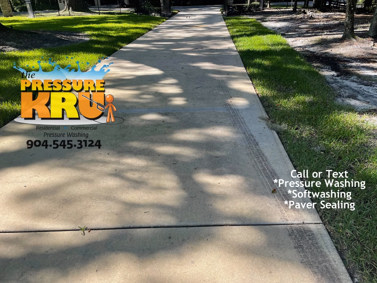 Pressure washing driveway in Saint Johns, FL. before soft wash treatment.