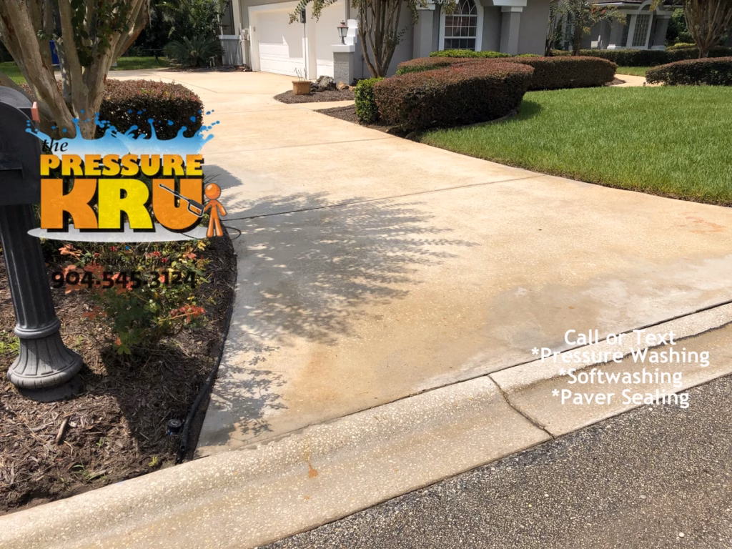 Pressure washing driveway in St. Johns, FL after restoration.