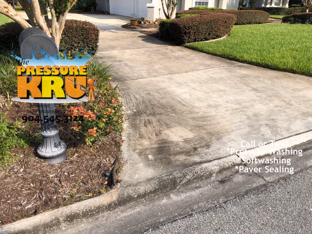 Pressure washing driveway in St. Johns, FL before restoration.