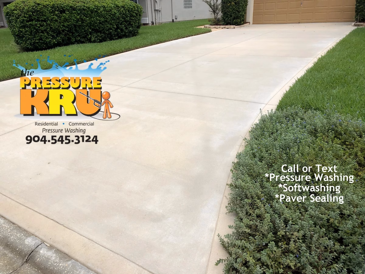 Pressure washing concrete driveway in remove organic staining in St. Johns, FL. After completed work.