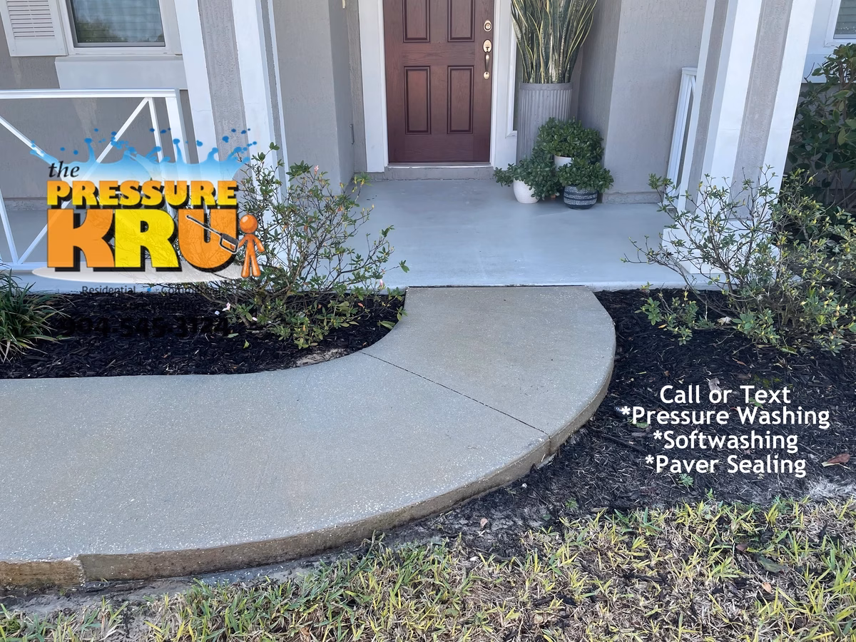 Freshly cleaned sidewalk and driveway in St. Augustine, FL after servicing.