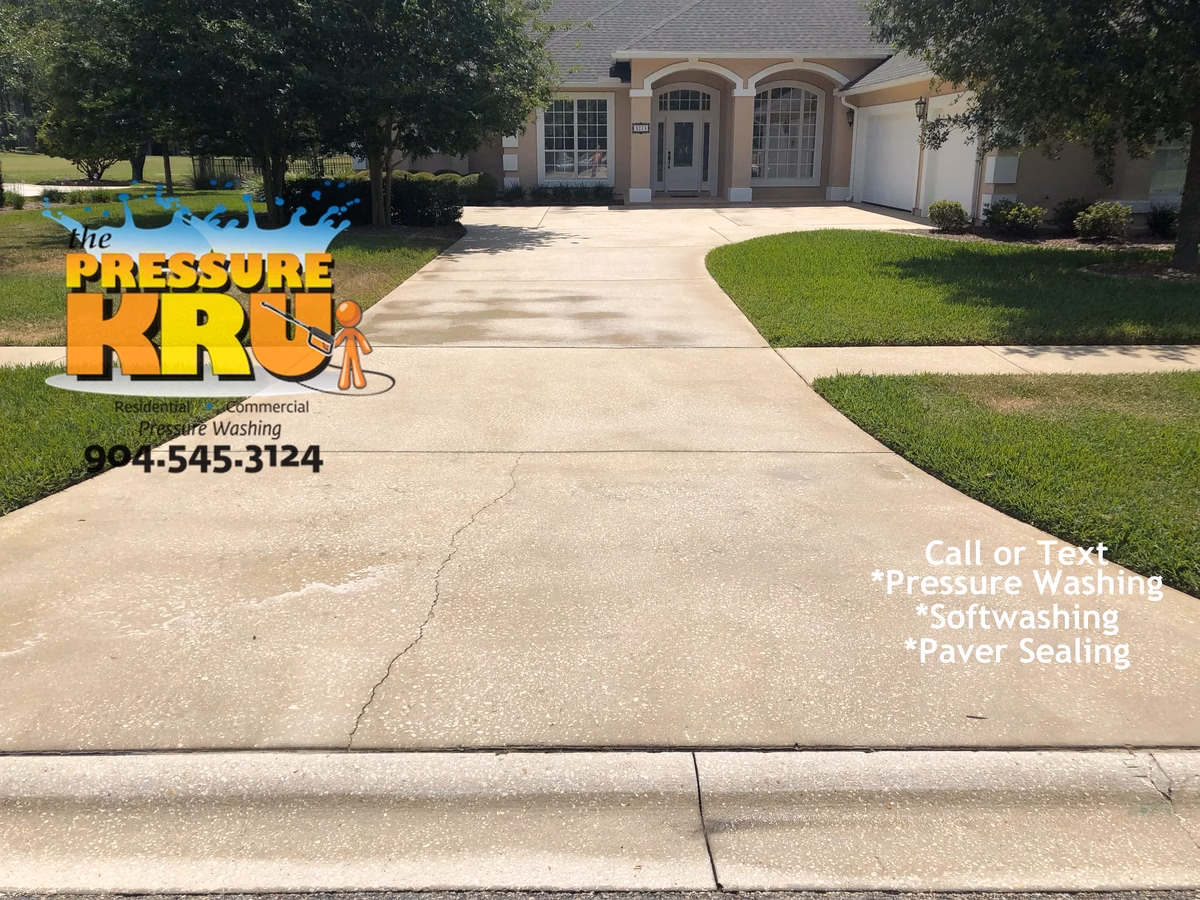 Residential concrete driveway before cleaning with professional pressure washing in St. Johns, FL.