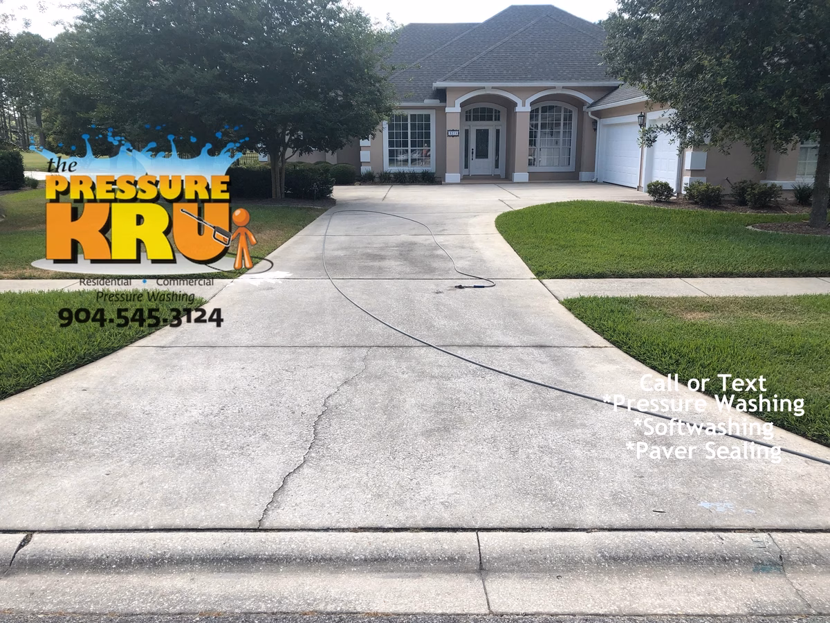 Residential concrete driveway before cleaning with professional pressure washing in St. Johns, FL.