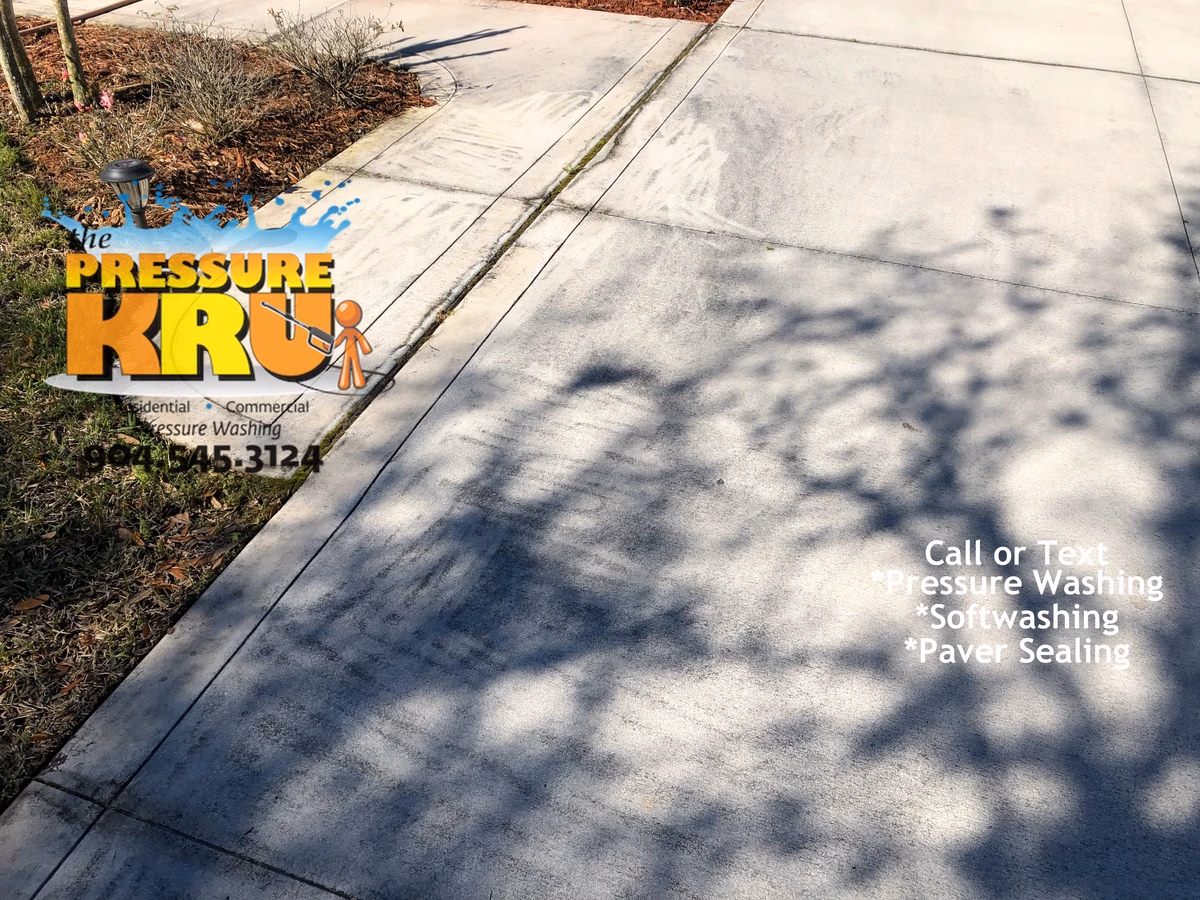Concrete driveway previously cleaned by home owner in St. Johns, FL. Notice wand marks where prior cleaning was all at the surface. Deep embedded mold not removed always leaves this as a result.