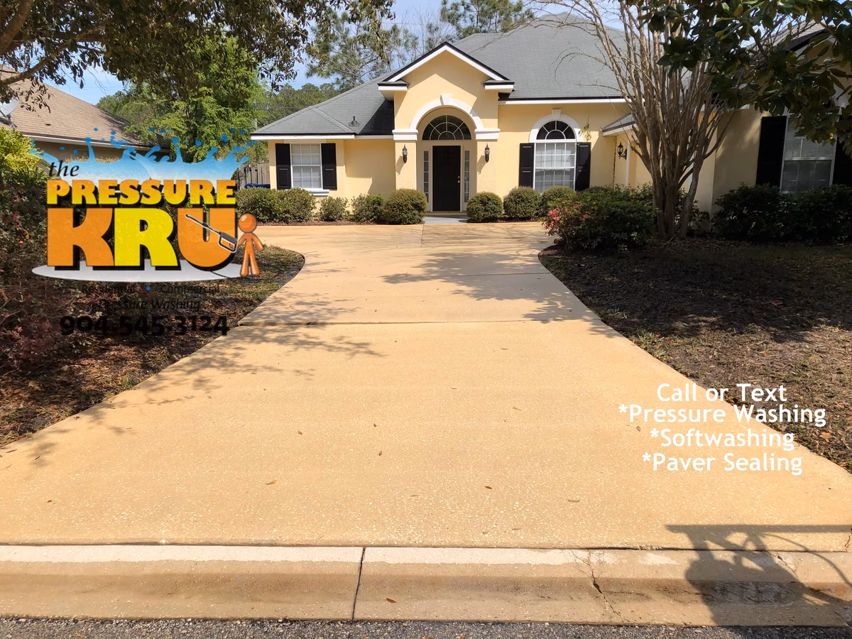 Pressure washing stained concrete driveway in St. Johns, FL after service.