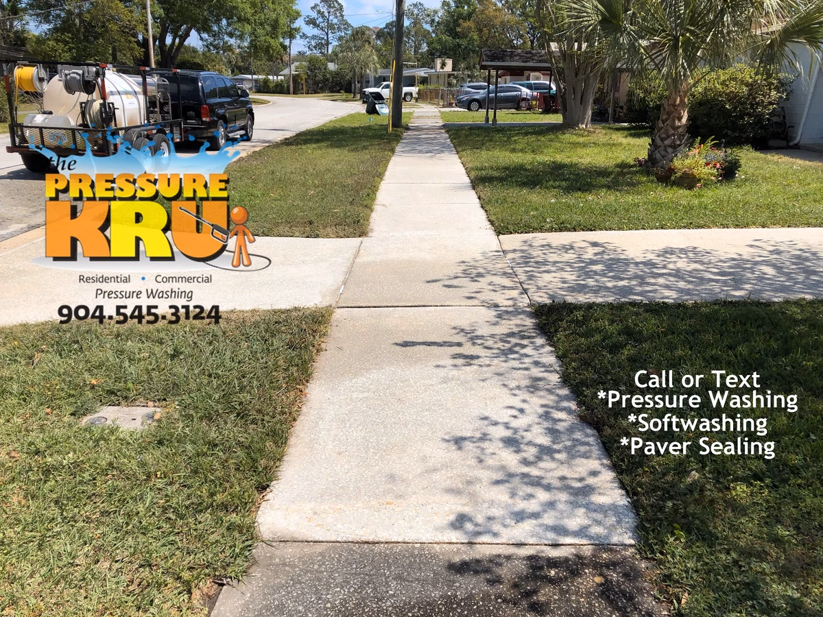 Professional driveway cleaning removing dirt and mildew in St. Johns, FL after listing home for sale.