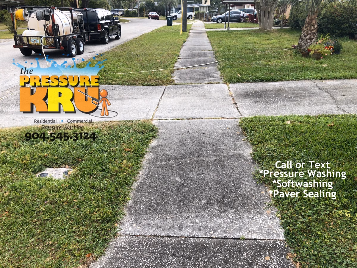 Professional driveway cleaning removing dirt and mildew in St. Johns, FL before listing home for sale.