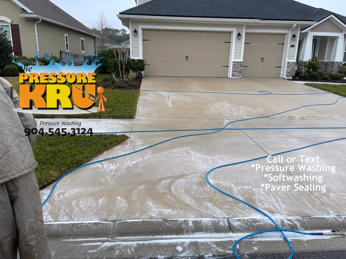 Residential concrete driveway cleaned in Jacksonville, FL. after soft washing. Chemical post treatment provides a deep cleaning of the pores.