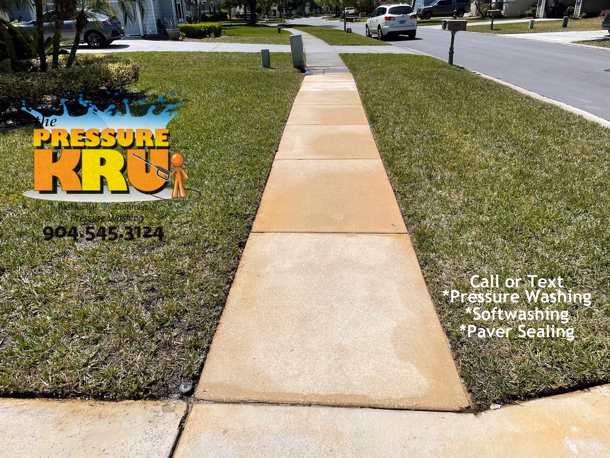 Residential concrete driveway and sidewalk after professionally cleaned in Ponte Vedra, FL