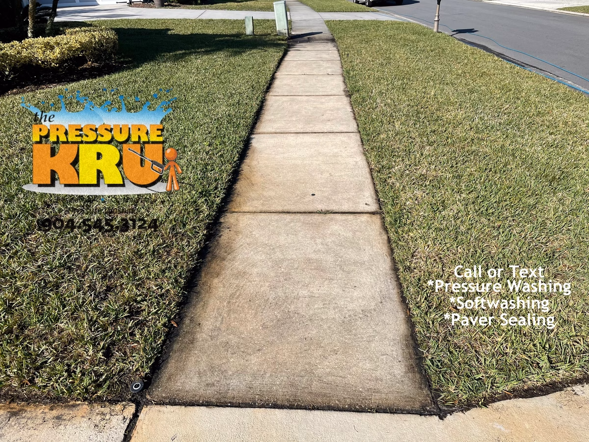 Residential concrete driveway and sidewalk before professionally cleaned in Ponte Vedra, FL