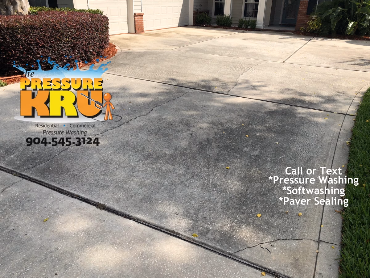 Before driveway pressure washing restoring bright concrete in St. Augustine, FL.
