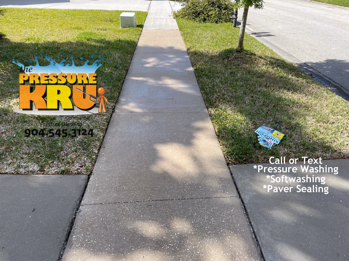 Driveway and walkway pressure washing in St. Johns, FL after chemical post treatment. Notice how prior home owner mold stripes were removed.