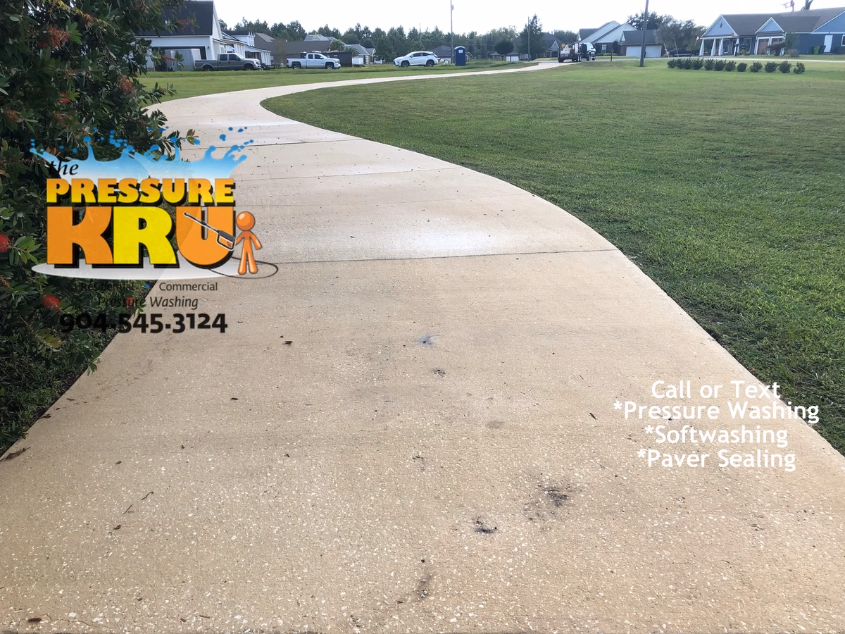 Driveway cleaning removing dark stains from concrete in St. Johns, FL after completing work.