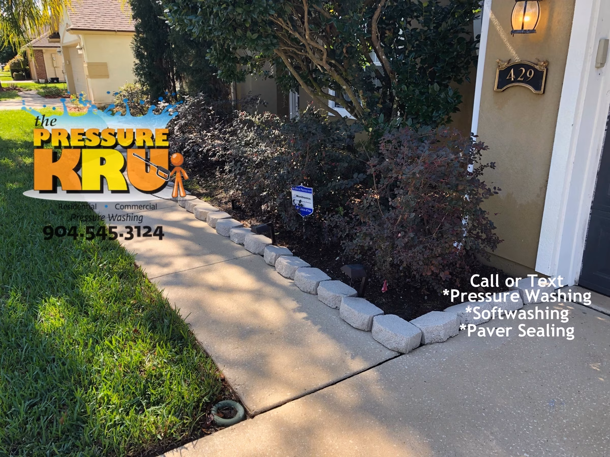 Exterior driveway and sidewalk cleaning with professional equipment and chemicals in St. Johns, FL before service.