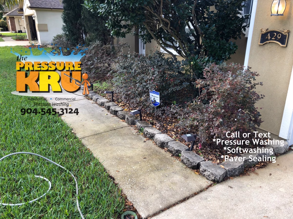 Exterior driveway and sidewalk cleaning with professional equipment and chemicals in St. Johns, FL before service.