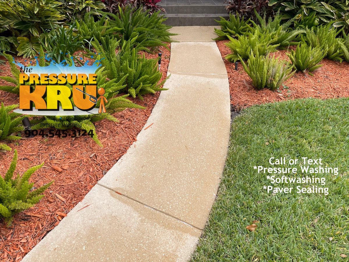 Residential driveway and sidewalks before cleaning in Saint Johns, FL.