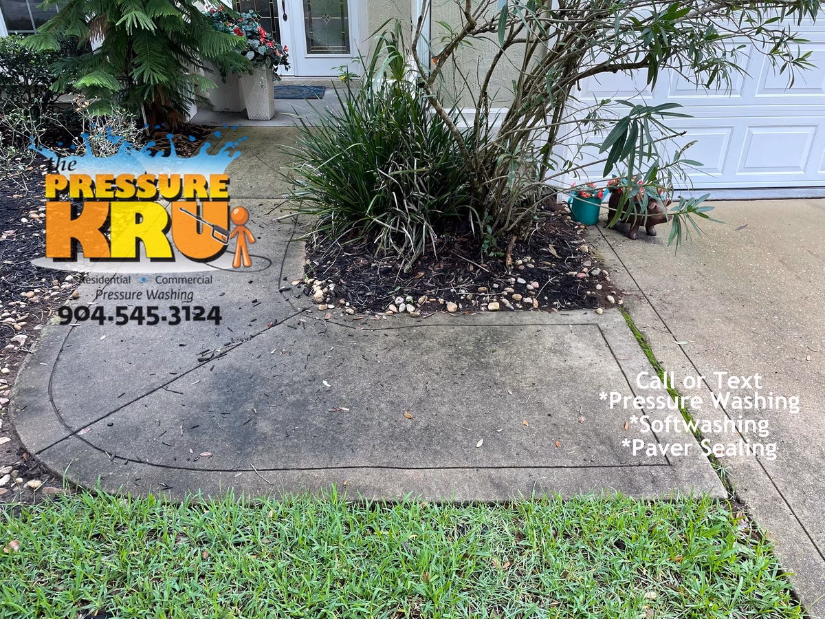 Pressure washing driveway in St. Augustine, FL 32092 before softwashing.