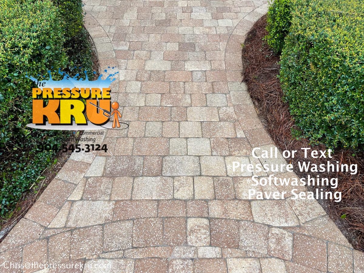 Applying eco-friendly cleaner to paver driveway after pressure washing in The Plantation.