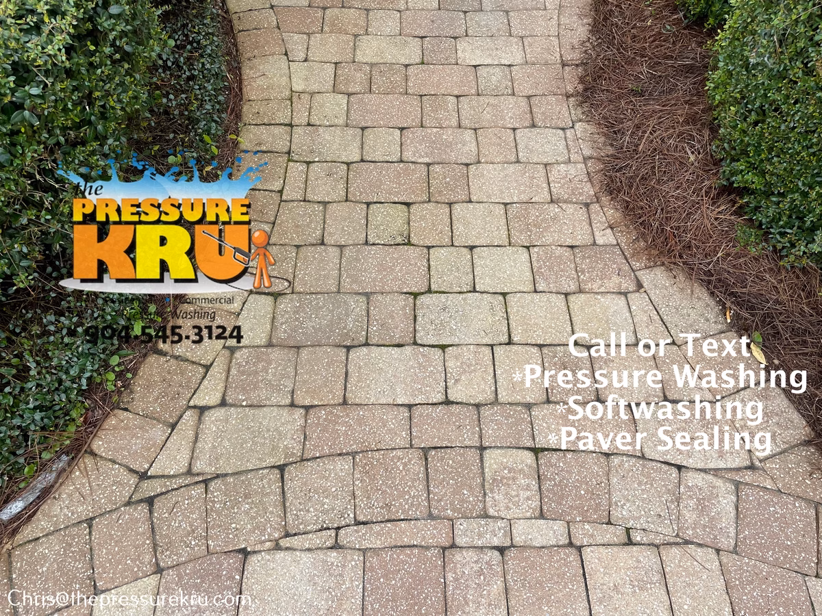 Applying eco-friendly cleaner to paver driveway before pressure washing in The Plantation.