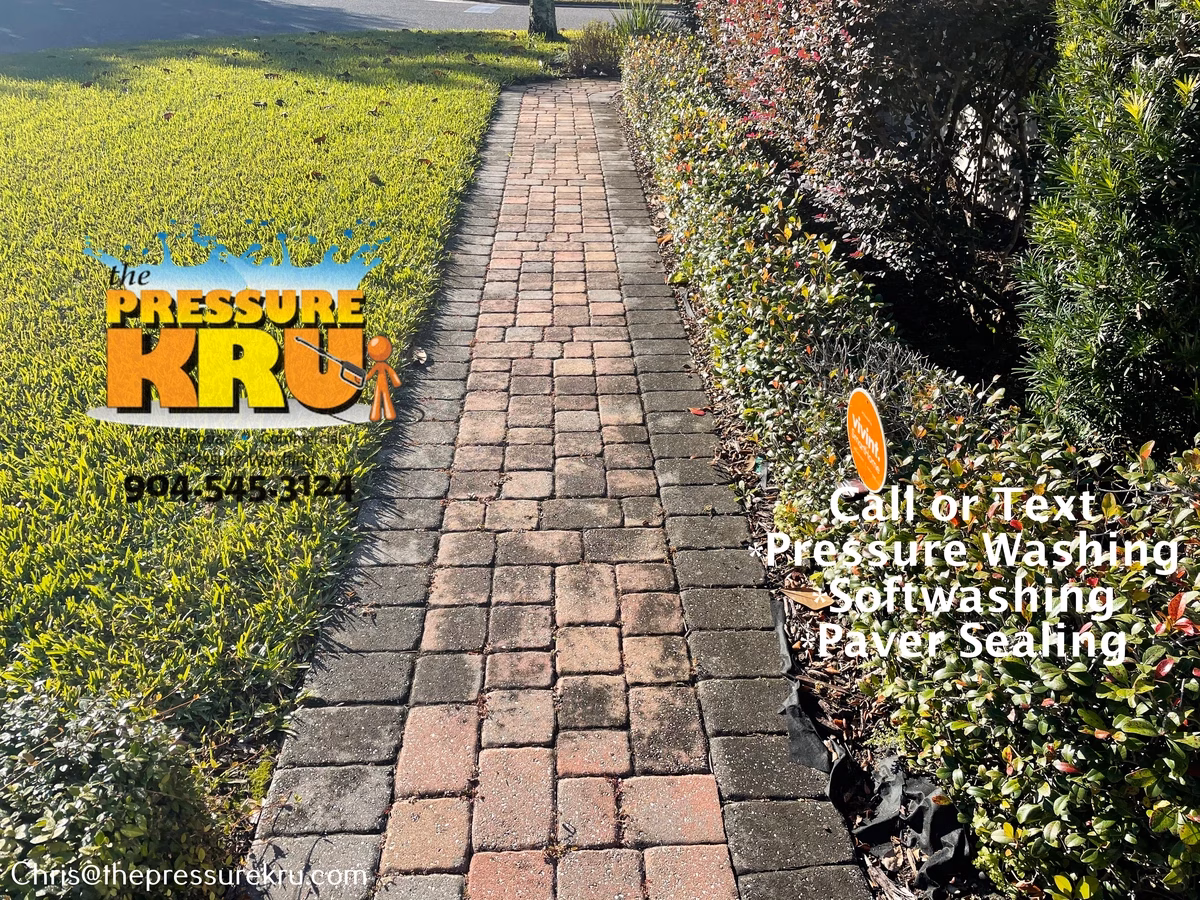 Professional pressure washing paver driveway before in Greenland Chase.