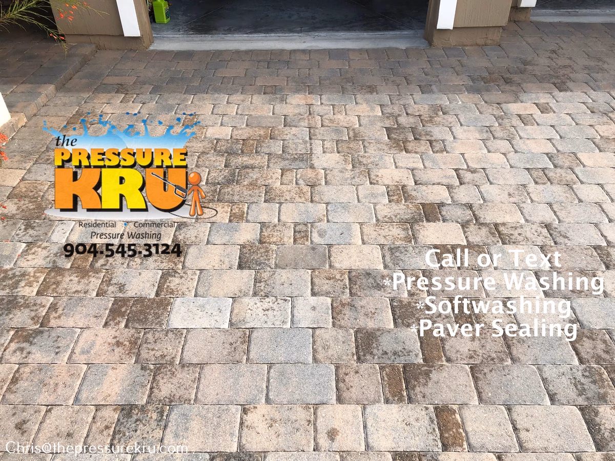 Oil Stained paver driveway before pressure washing in Mill Creek Forest,