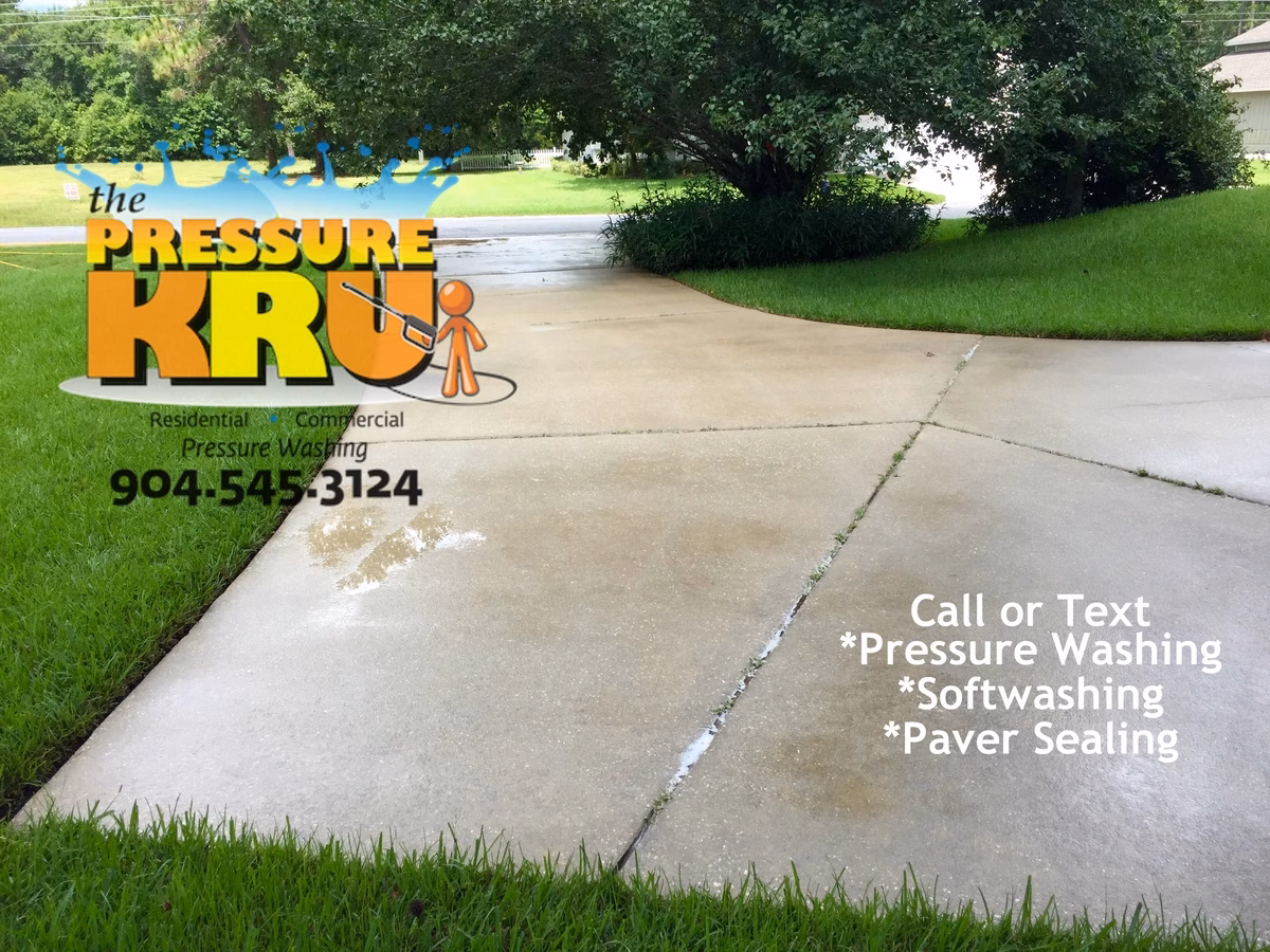 Driveway after pressure washing removing slippery algae from concrete in St. Augustine, FL 32092.