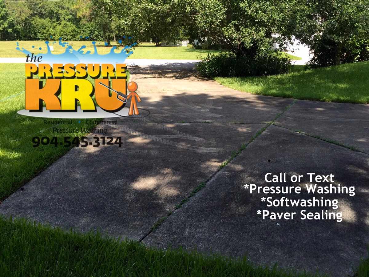 Driveway before pressure washing removing slippery algae from concrete in St. Augustine, FL 32092.