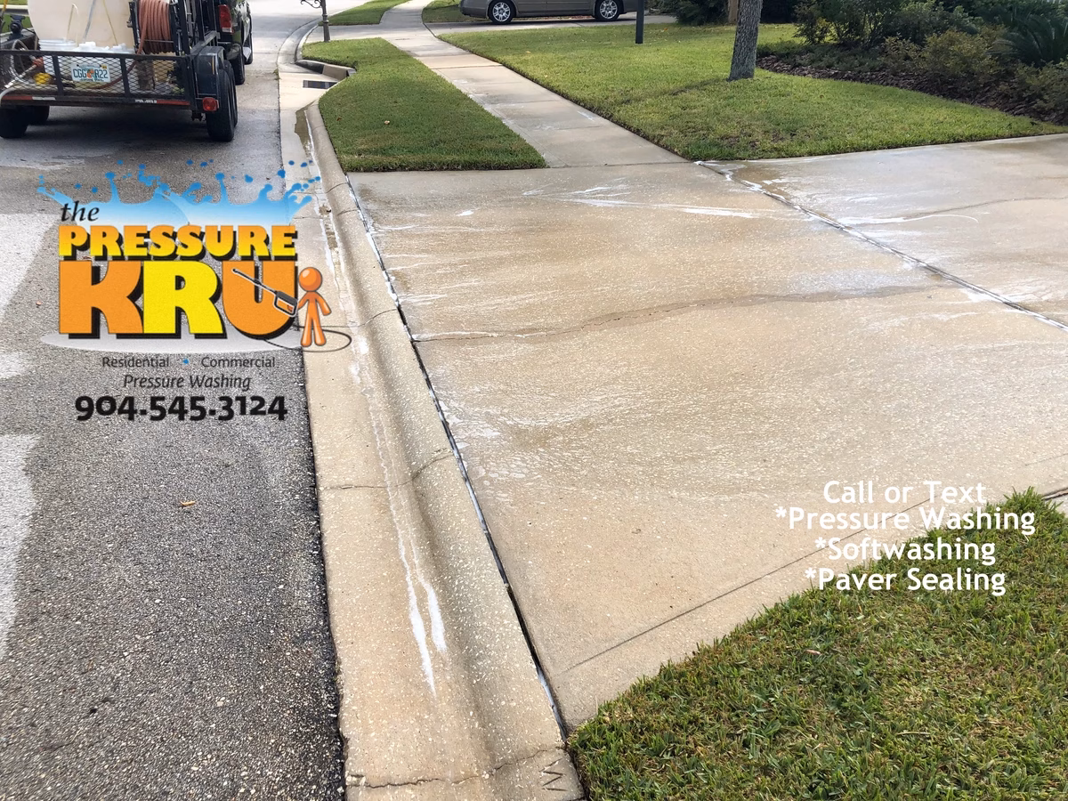 Pressure washing driveway with visible before and after cleaning results in Jacksonville, FL.