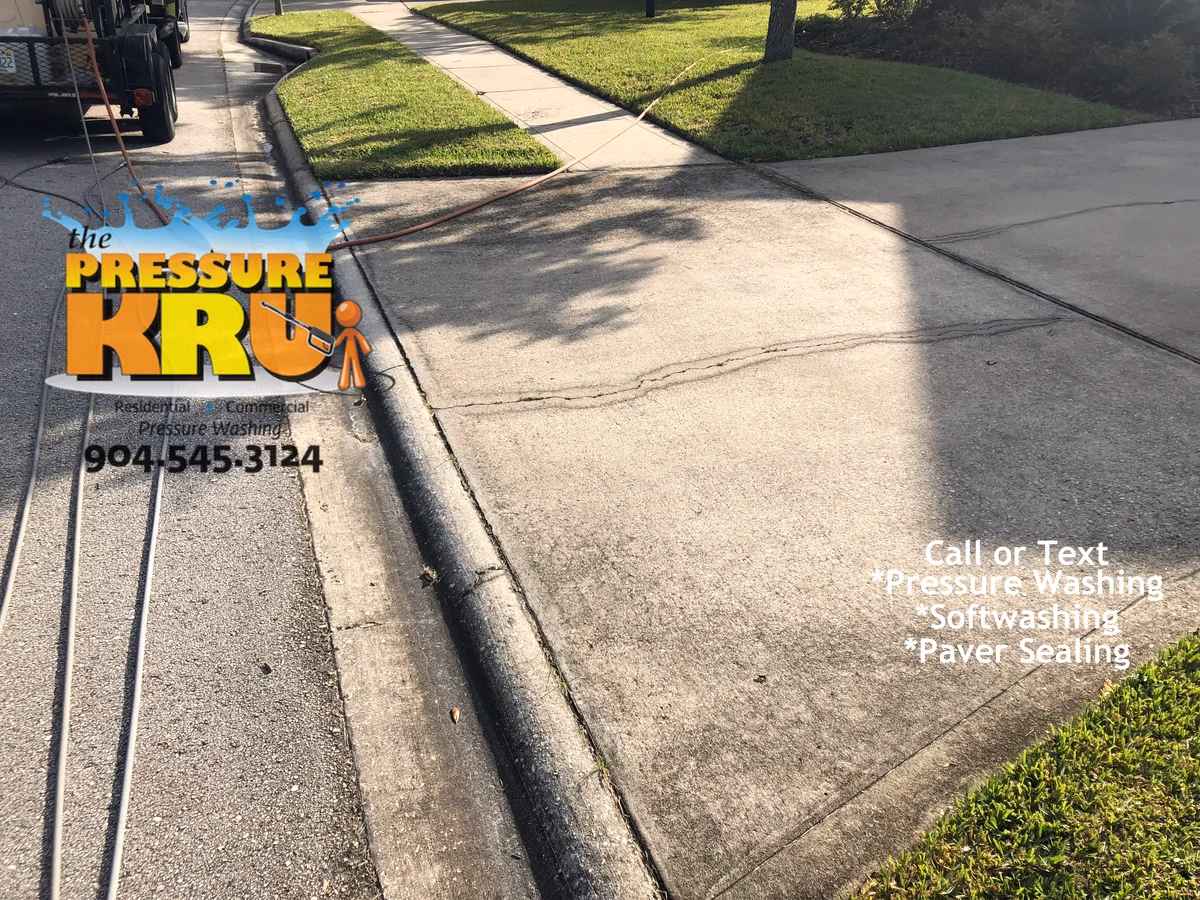 Pressure washing driveway with visible before and after cleaning results in Jacksonville, FL.